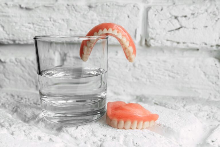 a denture in a glass of water dental prosthesis care full removable plastic denture of the jaws
