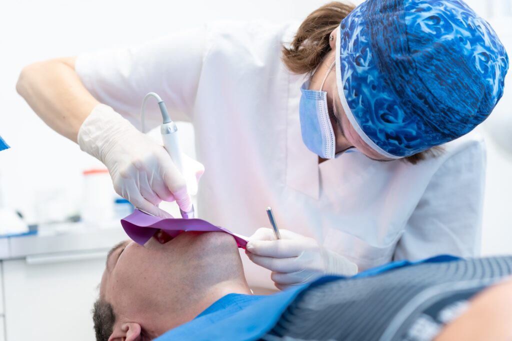 dental clinic a doctor performing a root canal to a patient in full operation