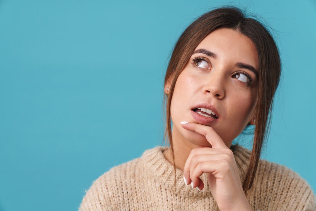 image of serious caucasian woman thinking and looking upward