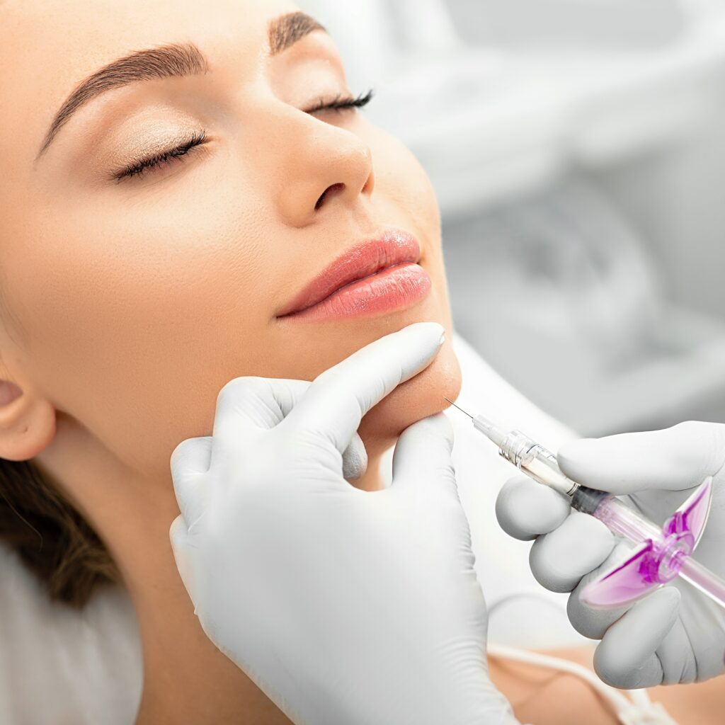woman during skin tightening procedure injection of dermal filler into a female face the anti