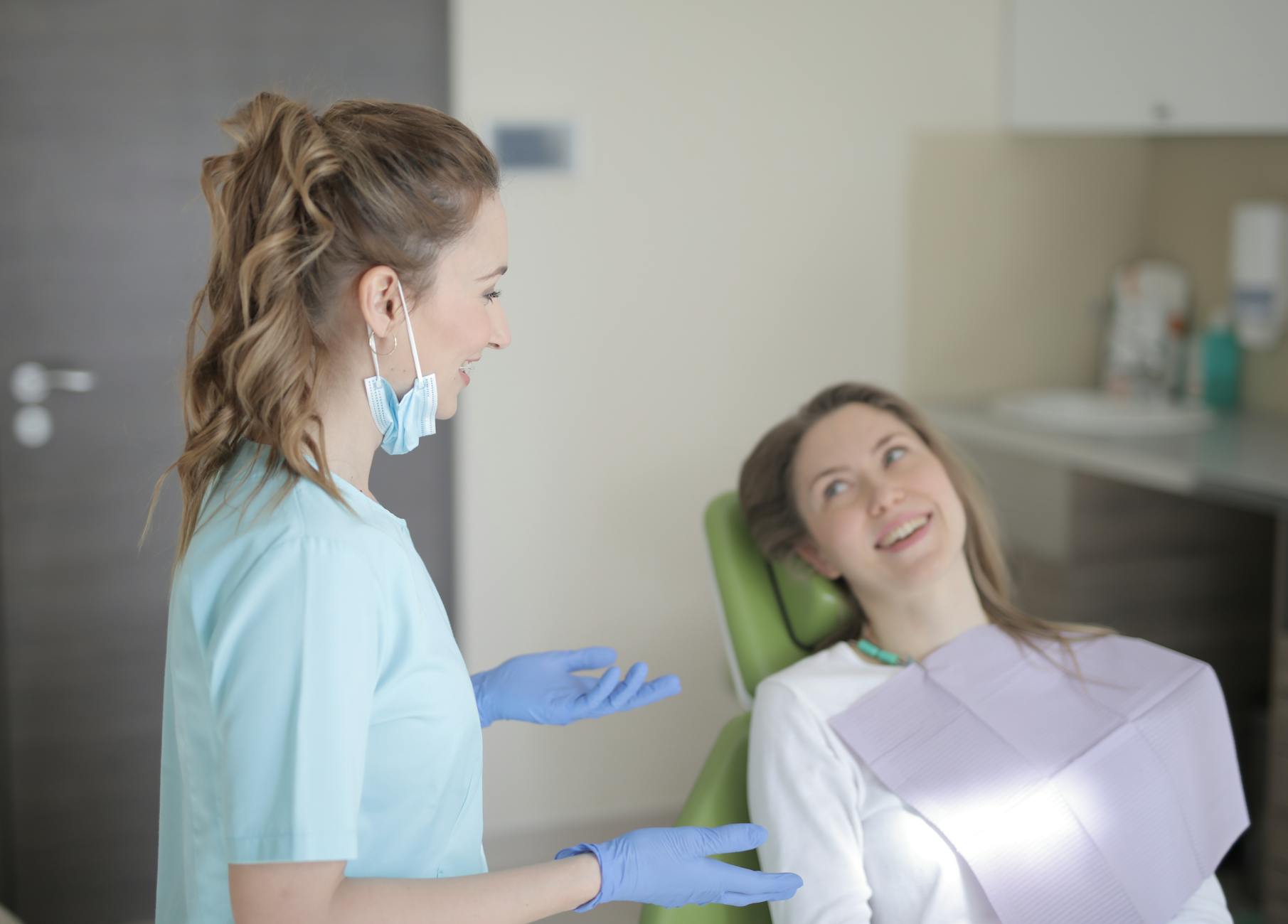compassionate dentist talking with nervous patient consultation